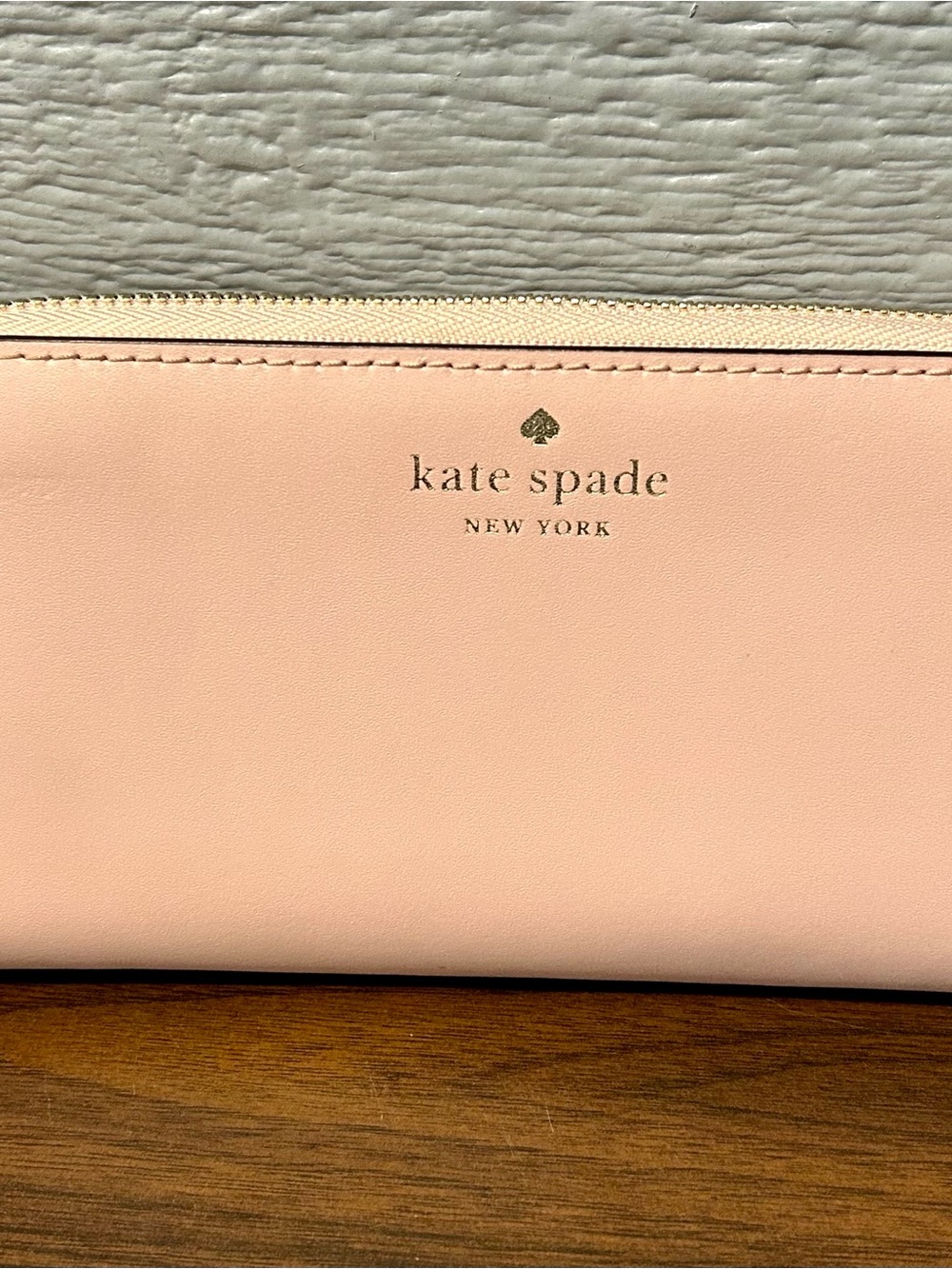 kate spade blush pink leather wallet with gold logo